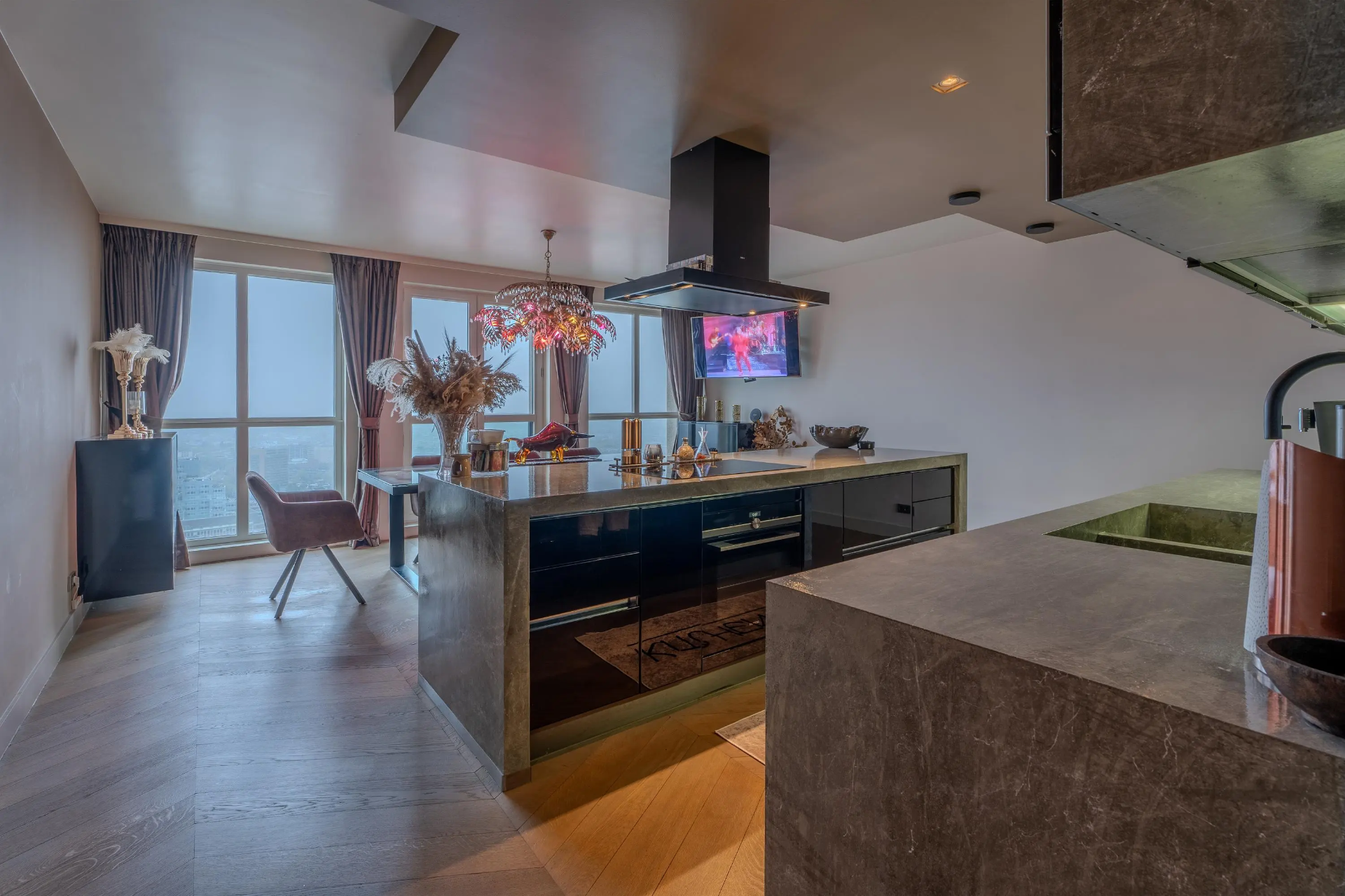 Stone kitchen inside the penthouse with city views
