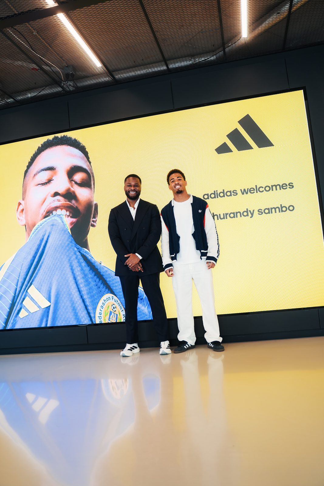Founder and Shurandy Sambo standing in front of the adidas welcome screen